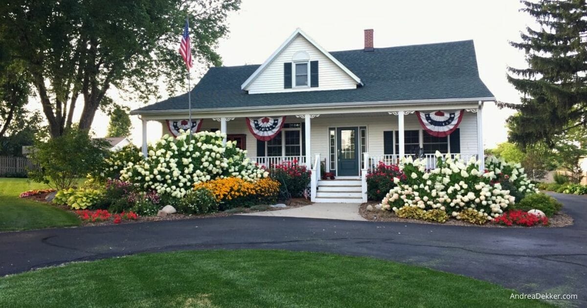 Colorful low maintenance perennial garden bed with blooming coneflowers, black-eyed susans, and other easy-care flowers